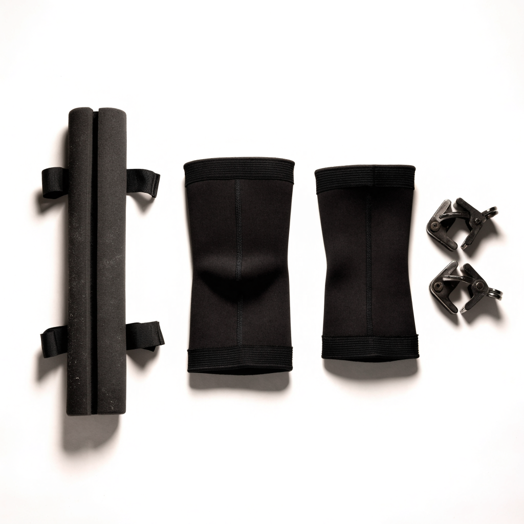 Squat Kit contents: hip thrust pad, two compression knee sleeves, pair of barbell collars