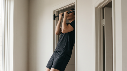 A lifter at the top of a pull up on a doorway pull up bar