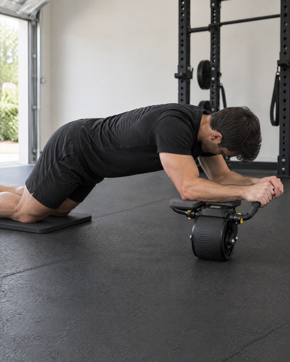 3-in-1 ab roller in use: forearms on the elbow pads, knees on the mat, rolling out in a garage gym