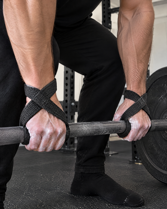 Lifter using black figure 8 lifting straps on a heavy barbell deadlift
