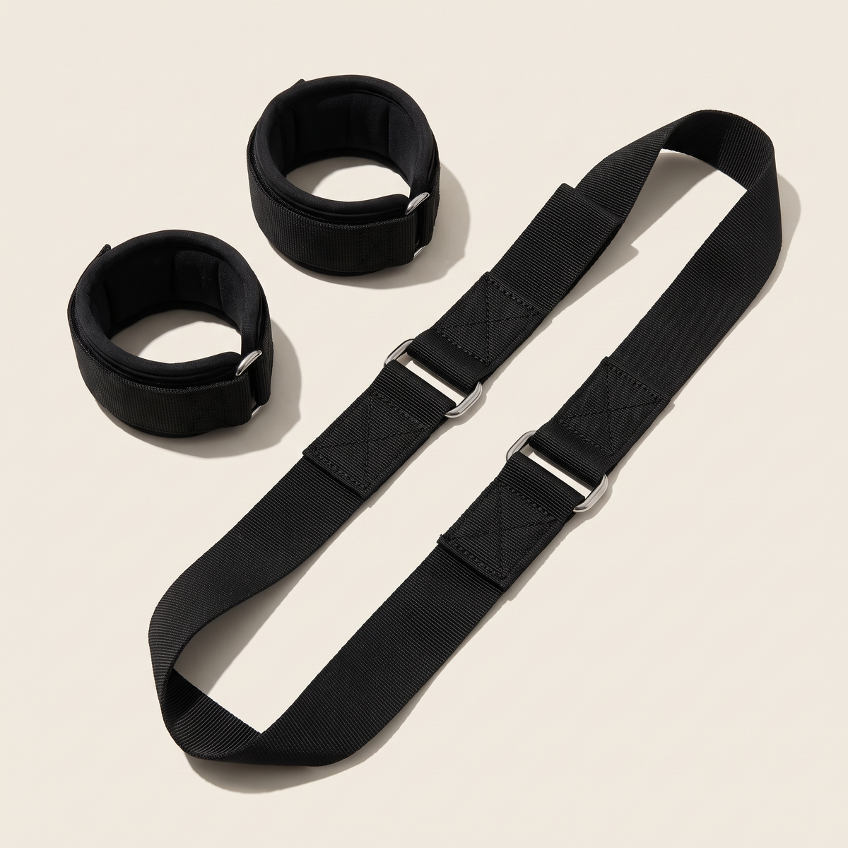 Nordic curl strap laid flat showing padded ankle cuffs and stitching