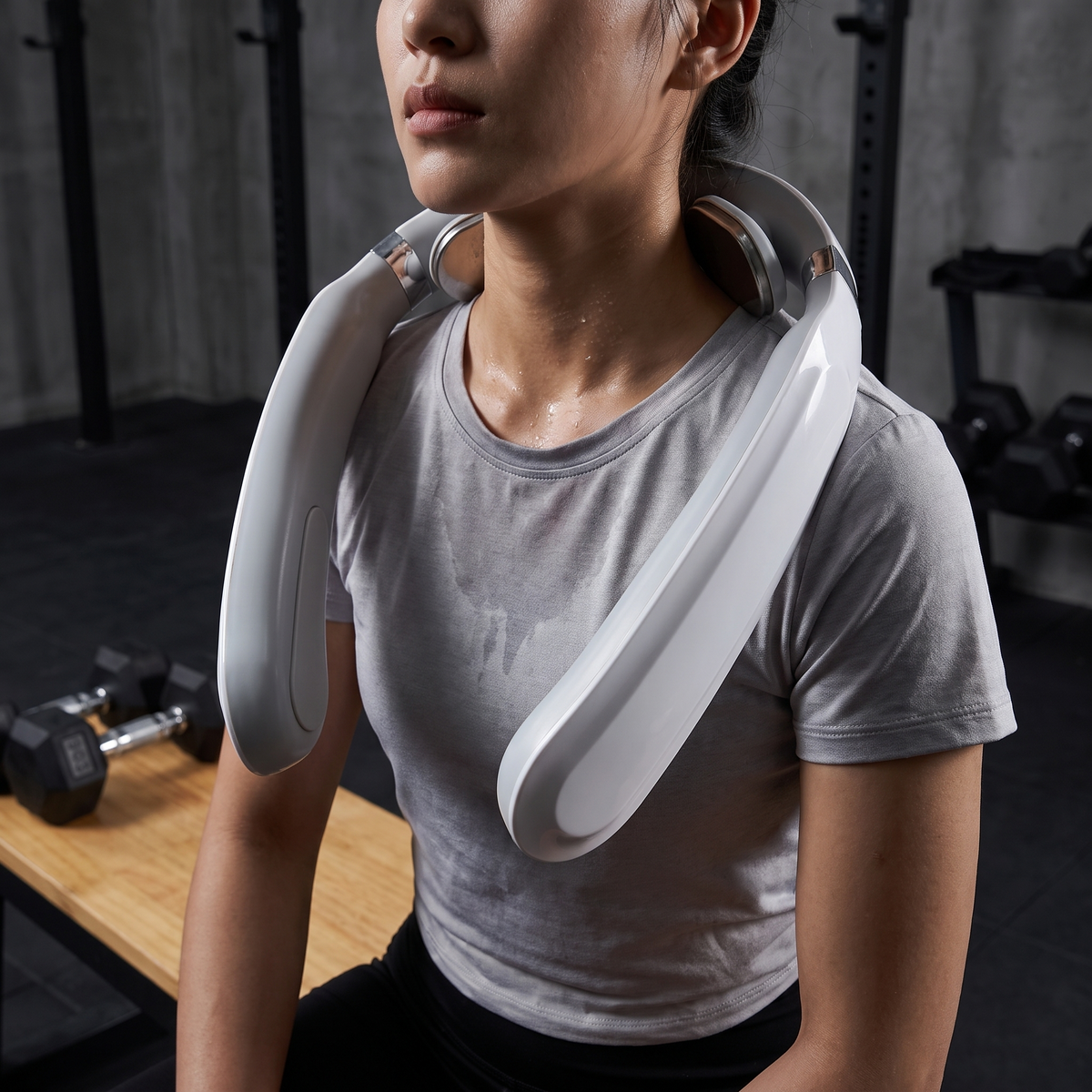 Neck and shoulder massager worn on a gym bench after training